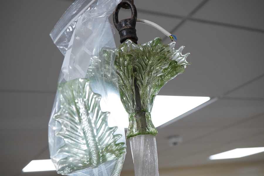An ornate leaf and floral green glass Murano three branch chandelier, 84cm high.